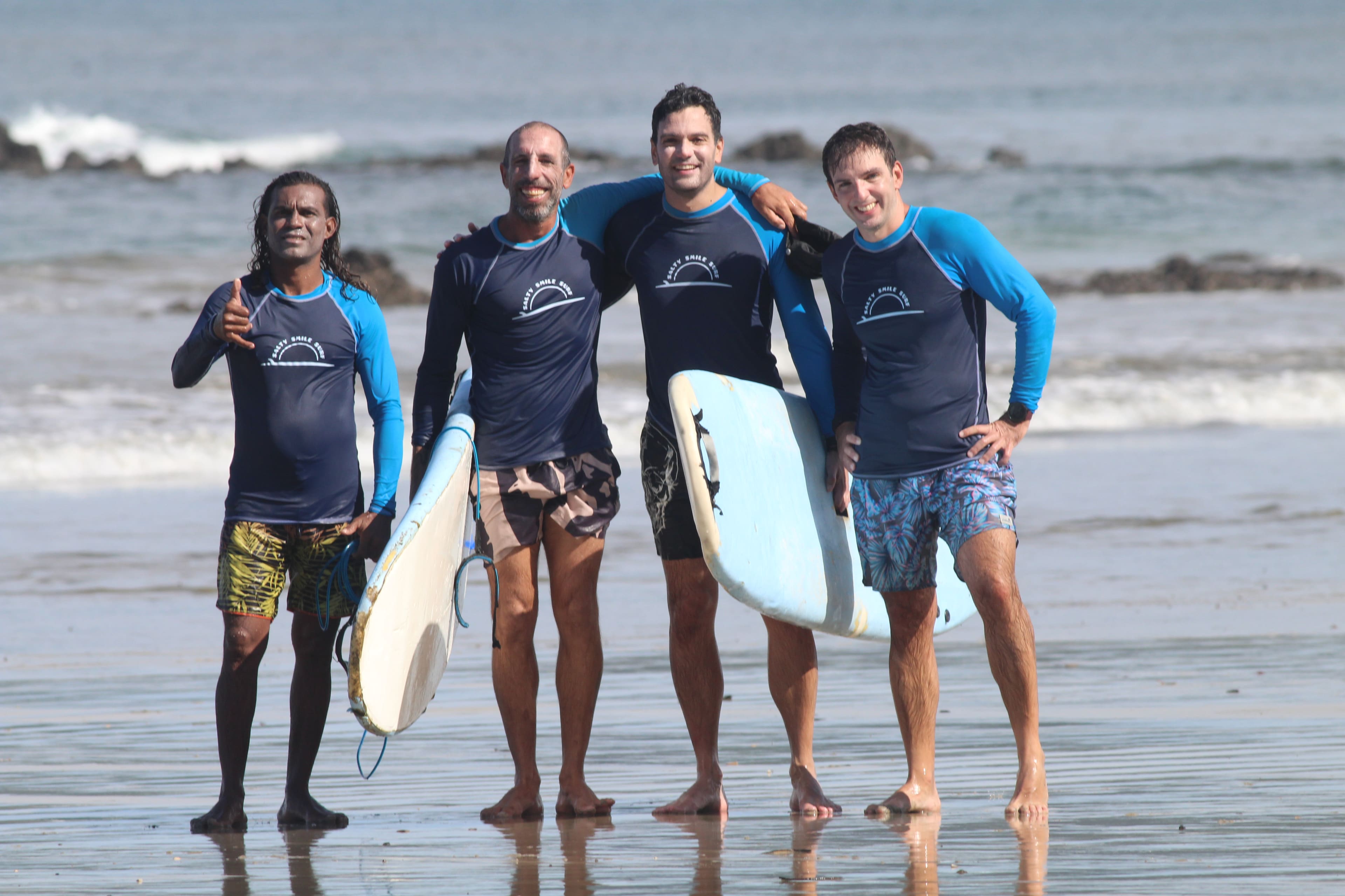 The Salty Smile surf instructors together on Tamarindo beach
