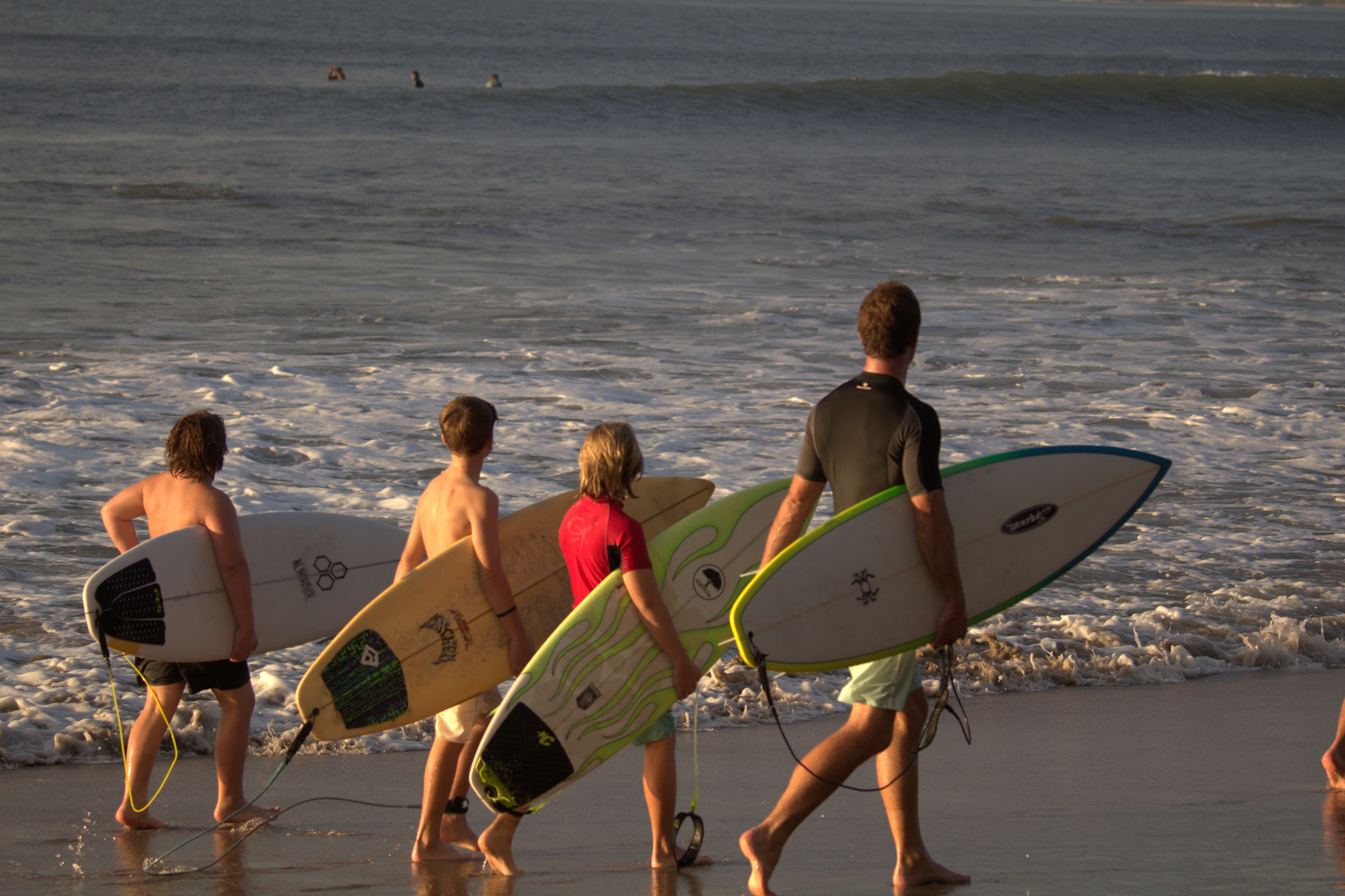 Surfers sharing a memorable day by the ocean